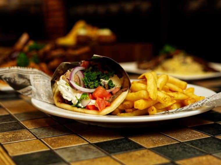 Signature gyros plated with sauces and fries